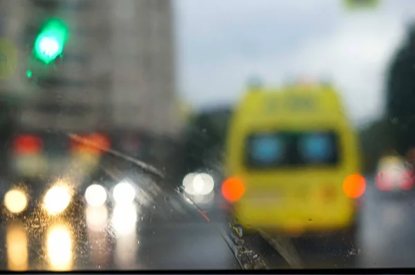 Emergency ambulance travels through city street.