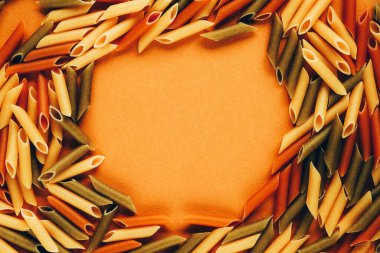 Renkli yeşil, sarı ve kırmızı makarnadan yapılmış çerçeve domates ve ıspanakla renklendirilmiş..