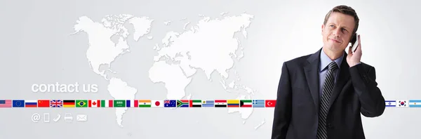 international contact us concept, businessman with mobile phone isolated on world map background, flags icons and contact symbols, web banner and copy space template