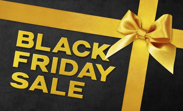 Black Friday texto venda escrever no cartão de presente preto com fita dourada — Fotografia de Stock