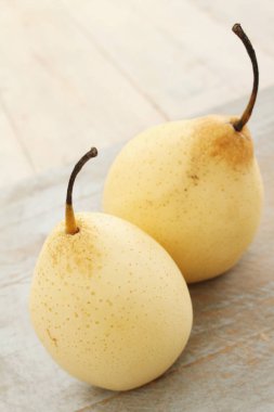 fresh chinese pears on wood background clipart