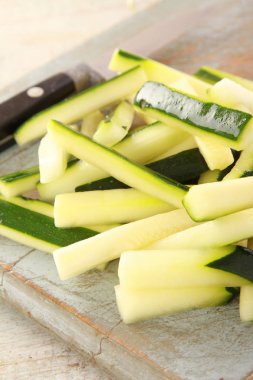 preparing courgette batons on the cutting board  clipart