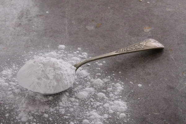 powdered confectioners sugar in the spoon