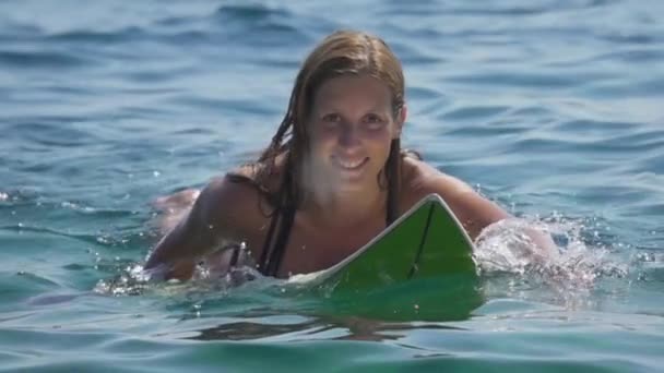 Slow Motion Close Vrolijke Vrouwelijke Surfer Liggend Surfplank Peddelen Uit — Stockvideo