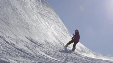 Ağır çekim: yapmak püskürtme hüner halfpipe duvar dudağında güneşli kışın büyük dağ kar Park, yarım boru sürme genç pro snowboarder