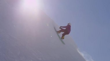 Ağır çekim: büyük dağ kar Park'ta yarım boru sürme, halfpipe duvardan ve güneş üzerinde atlama, hile ve rotasyonlar kapmak ile güneşli kışın gerçekleştirme genç pro snowboarder