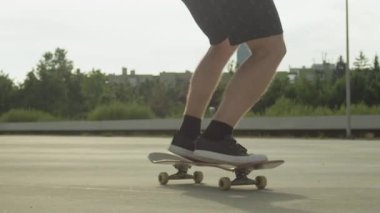 Ağır çekim Dof yakından: kaykay ve ollie atlama tanınmaz kaykaycı beton güneşli yaz aylarında sokak üzerinde numara çevir. Kickflip hile şehrin kaykay ile atlama kaykaycı