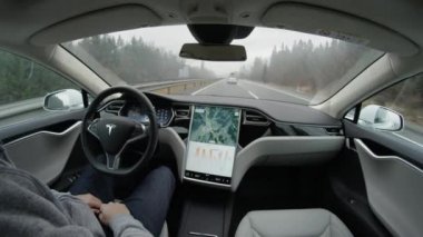 Özerk araba - 4 Şubat 2017: fast lane üzerinde hızlanan karayolu üzerinde direksiyon Self-driving Tesla Model S otomatik pilot. Tüm elektrik özerk araç sistemi karayolunda sürücü olmadan gezinme