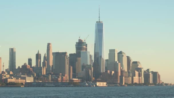 纽约市的地平线上著名的地标照亮了金色的夜空 标志性的一个世界贸易小跑反映周围的摩天大楼和办公楼在其玻璃幕墙 — 图库视频影像