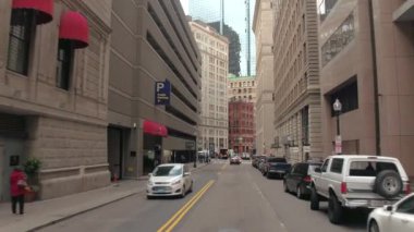Boston, Amerika Birleşik Devletleri - 15 Ekim 2016: Kalabalık cadde sürüş, bisiklet yolu ve araçların park boyunca caddesine doğru şehir merkezi ve uzun boylu camsı gökdelen ve idari bina