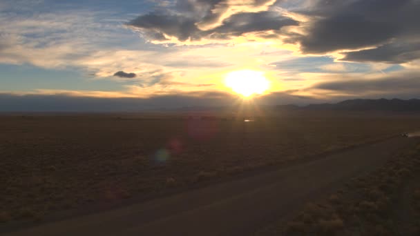 Aerial Flying Black Suv Car Driving Desert Valley Dramatic Sunset — Stock Video