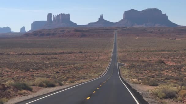 第一人称视角沿着一条笔直的空路驶向美国犹他州标志性的纪念碑山谷 Pov 旅行在品牌新公路与黄色标记的纪念碑山谷沙漠景观 — 图库视频影像