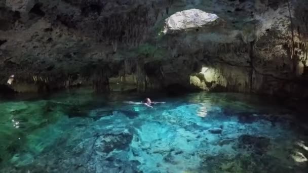 Young Woman Swimming Turquoise Pool Magical Underground Cave Sunlight Coming — Stock Video