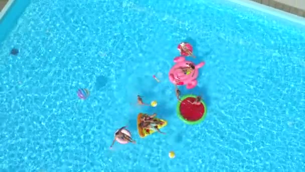 Aerial Cheerful Friends Having Water Fight Colorful Floaties Pool Party — Stock Video