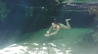 Sualtı: Nefes kesen kristal berraklığında yeraltı nehri ve Meksika Gran Cenote mağara keşfetmek yeşil bikini dalış çekici genç kadın. Doğal lavaboda yeraltı suyunda yüzen kız