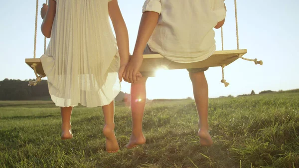 Closeup Lense Flare Unrecognizable Kids Sitting Big Wooden Swing Sunny — Stock Photo, Image