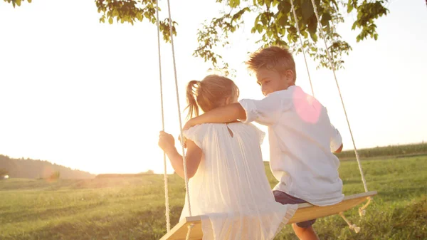 Cerrar Lense Flare Joven Abrazando Enamoramiento Balanceándose Columpio Madera Atardecer — Foto de Stock