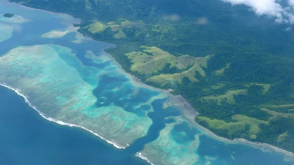 航空写真 見事なターコイズ ブルーの海の波にオーバー大規模なサンゴ礁 美しいエキゾチックな島へ 息をのむような青い海と太平洋の太陽に照らされた熱帯の楽園の島の上の飛行 — ストック写真
