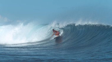 Deneyimli sörfçü popüler sörf oracıkta bir büyük kristal berraklığında varil dalga sürmek. Harika erkek surfboarder bir büyük derin mavi dalga güçlü okyanus tarafından geliyor açmaktadır. Adrenalin dolu yaz etkinliği.