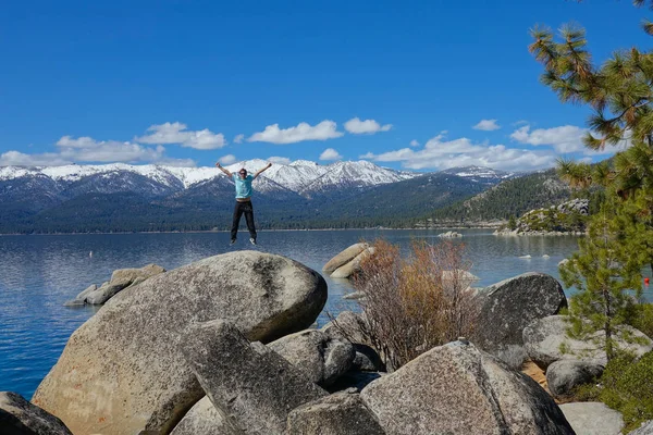 Cheerful Male Jumps Air Outstretched Arms Beautiful Lake Tahoe Happy — Stock Photo, Image