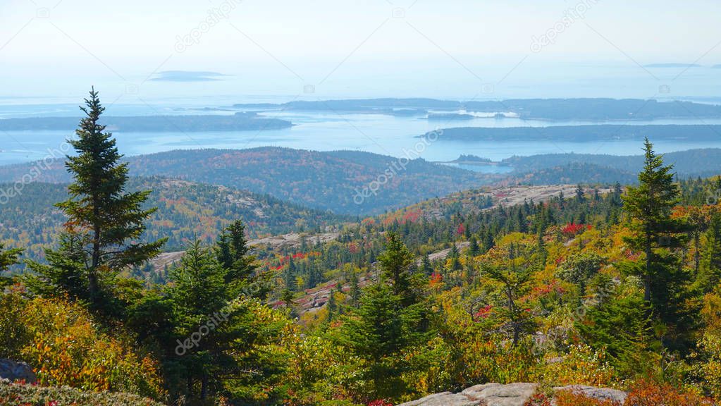 AERIAL: Flying over the colorful woods in the breathtaking National Park in Maine. Leaf peeping in the picturesque wilderness of Vermont. Large lakes and vast deciduous forests with vivid canopies.