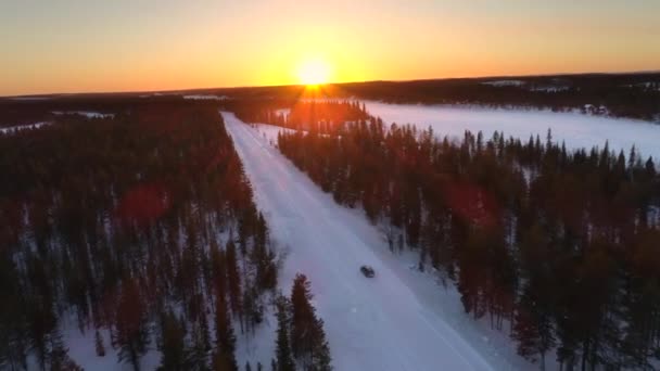 Aerial Flying Car Driving Snowy Forest Golden Winter Sunrise People — Stock Video