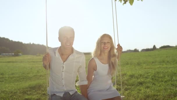 Slow Motion Close Joyful Boyfriend Girlfriend Smiling Swaying Rope Swing — Stockvideo