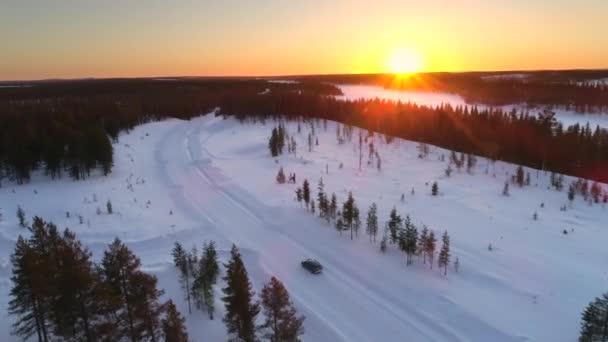 Aerial Flying Car Driving Snowy Forest Golden Winter Sunrise People — Stock Video