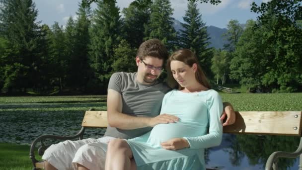 Portrait Excited Father Rubbing Baby Mother Pregnant Belly Beautiful Green — Stock Video