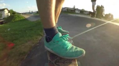 Düşük Açı, Close Up, Lens Flare: Akşam güneş ışınları eğlenceli paten parkta eğlenceli kaykay genç adam aşağı ışınlar. Küçük köpek arkasında koşarken pro erkek longboarder güneşli pompa parça boyunca sürmek.