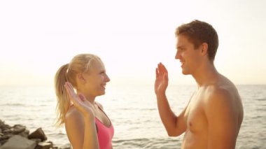 Genç erkek arkadaşı ve kız arkadaşı birlikte güneşli sahilde jogging. Huzurlu okyanus boyunca sportif Tarih jog üzerinde kadın aktif adam. Yaz aylarında açık havada egzersiz mutlu çift.