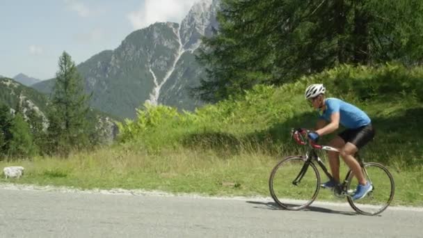 Slow Motion Young Athletic Man Slowly Cycling Steep Asphalt Road — Stock Video