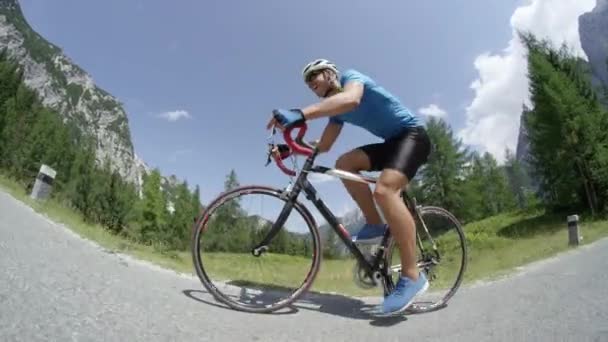 Close Low Angle Athletic Bike Rider Riding Uphill Asphalt Road — Stock Video