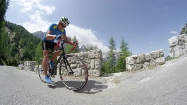 Slow Motion Low Angle Athletic Male Cyclist Pedalling Uphill Mountain — Stock Video