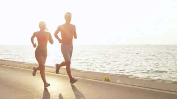 Lens Flare Copy Space Smiling Fit Caucasian Couple Jogging Shirtless — ストック動画