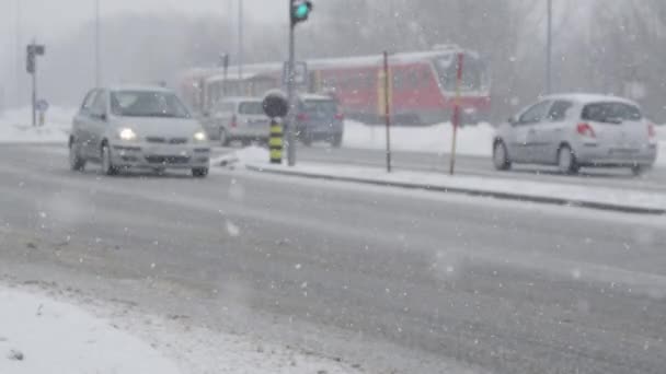 スローモーション Dof 危険な吹雪の中で滑りやすい道路を運転市内交通 寒い冬には 滑らかなアスファルトの通りを慎重にナビゲートします 雪の状態はドライバを減速 — ストック動画