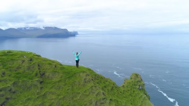 Aerial Unrecognizable Girl Outstretched Arms Standing Edge Grassy Cliff Celebrates — Stock Video