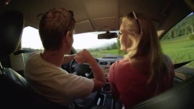 Slow Motion, Close Up: Enerjik Kafkasyalı çift yaz aylarında harika bir yaz sabahı kırsal alanda eğleniyorlar. Neşeli sevgili arabada dans ediyor..