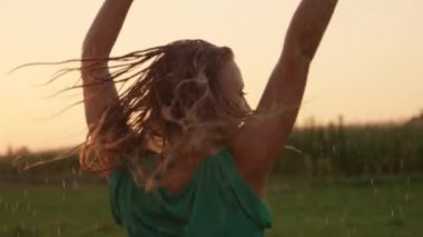 Slow Motion, Close Up, Lens Flare: Yeşil sundress çekici kadın yağmurlu bir bahar sabahı doğada döner. O hoş yaz yağmurda dans ederken Easygoing sarışın kız sırılsıklam olur.