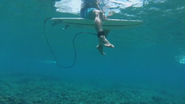 Slow Motion Underwater Unrecognizable Surfer Sits His Surfboard While Waiting — Stock Video