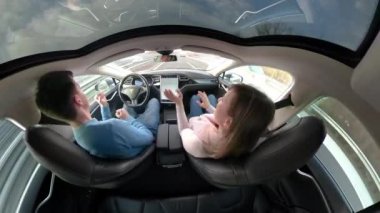 Tesla özerk arabayı, Mart 2018 - yakın: kaygısız iki özerk bir Tesla araba sürüş sırasında dans. Pervasız sürüş ve yol kendini direksiyon araca dikkat kadın ve.