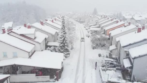 Aerial Car Drives Snowy Road Leading Suburban Neighborhood Kids Enjoying — Stock Video