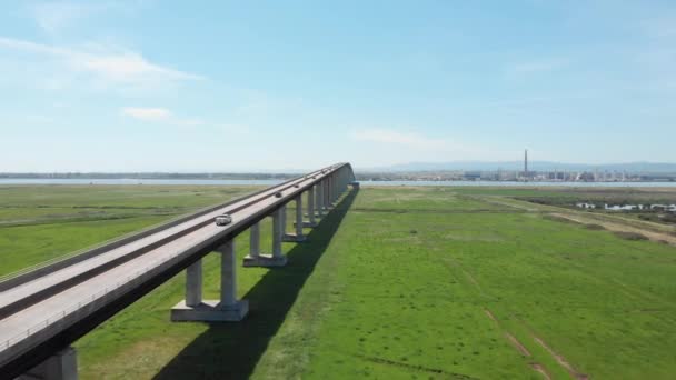 Aerial Flying Large Concrete Bridge Leading Traffic Distant Industrial Town — Stock Video