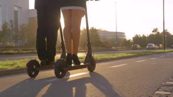 LOW ANGLE: Cinematic shot of e-scooters as work colleagues commute from work. — Stock Video