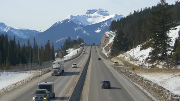 AERIAL: Cargo trucks and cars drive down the famous scenic Trans Canada Highway. — Stock Video