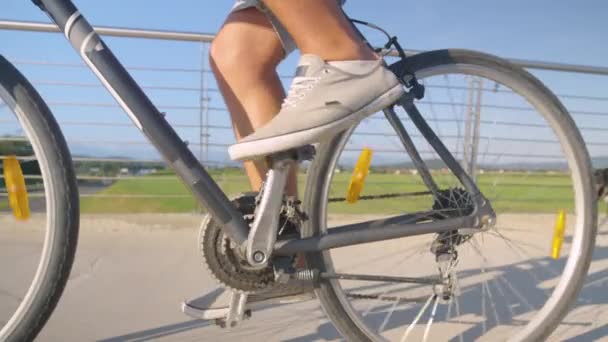 CLOSE UP: Aktivní mladý muž dojíždí do práce za slunečného letního dne na kole — Stock video