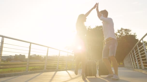 LOW ANGLE: Newlyweds celebrate going on honeymoon while walking to the airport. — Stock Video