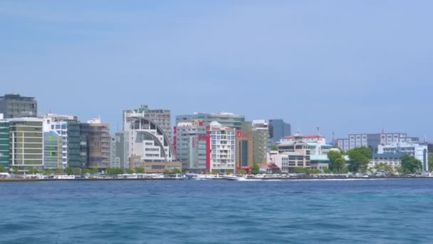 Scenic water taxi ride offers a view of modern skyscrapers on the coast of Male — Stock Video