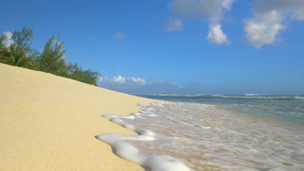 Camsı okyanus suyunun beyaz kumlu sahili yıkarkenki görüntüsü. — Stok video