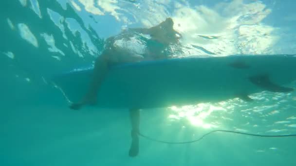 UNDERWATER: Woman on vacation in Barbados sits in line up, waiting for waves. — Stock Video